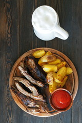 Traditional German beer snacks are potatoes, cabbage, grilled meat on ribs and a pint of beer.