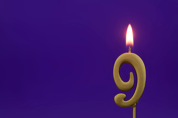Burning golden birthday candles on blue background with space for text, number 9