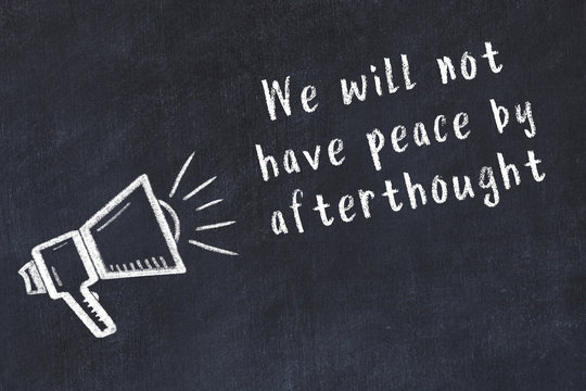 Chalk loudspeaker and wise quote on black desk