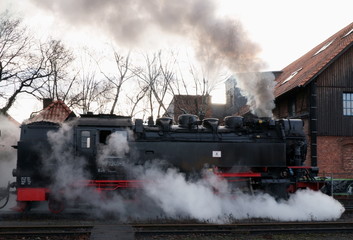 Fototapeta na wymiar Black and red steam locomotive at Brocken railway station in Harz Mountains