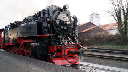 Fototapeta premium Black and red steam locomotive at Brocken railway station in Harz Mountains