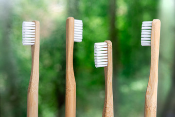 bamboo toothbrushes close-up on a background of nature. green bokeh. biodegradable materials....