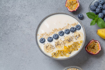 Coconut yogurt smoothie bowl with blueberries, banana, passion fruit and Chia seeds. Healthy delicious Breakfast