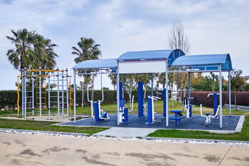 Exercise machines and fitness equipment for sports workout in the outdoor gym in city park