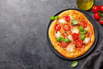 Tasty homemade pizza with tomatoes and basil