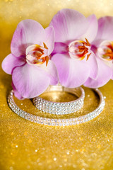 Bracelet and necklace on a gold shiny background
