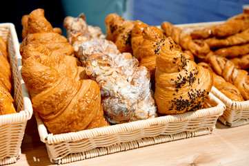 A variety of sweet buns and croissants.