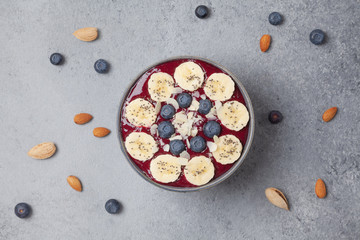 Berry smoothie bowl with blueberries, banana, almonds, Chia seeds and coconut flakes. Healthy and delicious Breakfast.