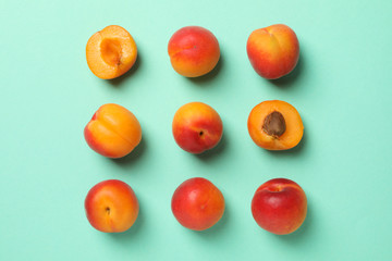 Flat lay with tasty apricots on mint background