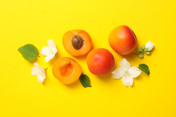 Fresh tasty apricots on yellow background, top view
