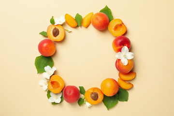 Circle made of apricots on beige background, space for text