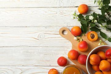 Plakat Composition with tasty apricots and jam on white wooden table