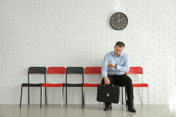 Man waiting for his turn indoors