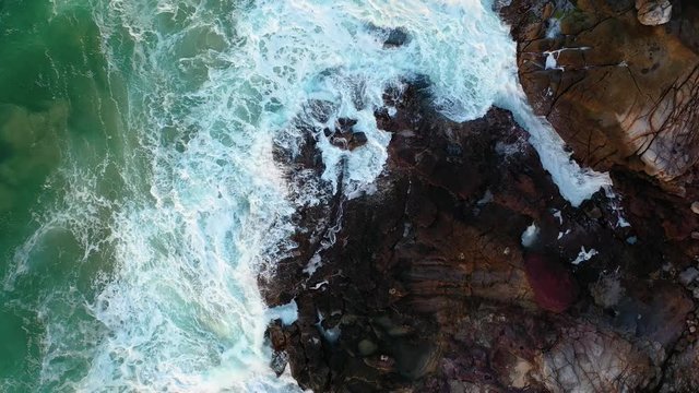 Smashing waves on rocks at Coolum headland. Sunshine Coast, Coolum, Queensland, Australia.