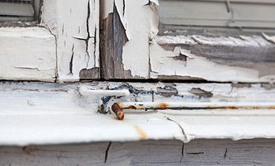 windowsill where the color is flaking and the wood cracked
