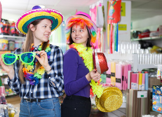 Girls joking in festive accessories shop