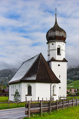 Fototapeta na wymiar Mariahilf chapel in Tannheim (Tyrol, Austria) at spring sunrise