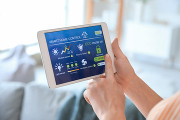Woman using application of smart home automation