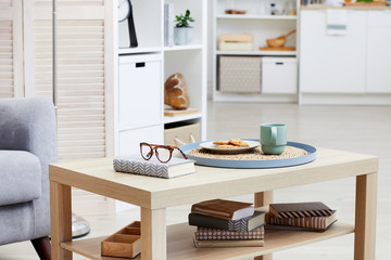 Close-up of tea with biscuits on the tray are on wooden table in the living room at house