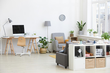 Image of living room with workplace with computer and armchair in the house