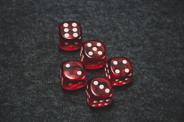 red dice on grey background and poker cards
