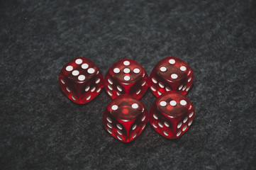 red dice on grey background and poker cards
