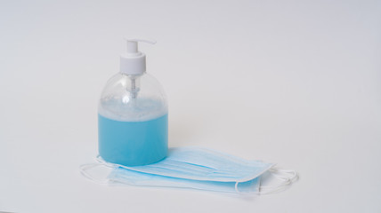 Surgical face mask and alcohol gel protect yourself from COVID-19. Medical concept