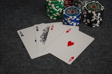 playing cards and poker chips on grey background
