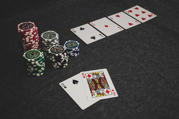 playing cards and poker chips on grey background