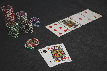 playing cards and poker chips on grey background