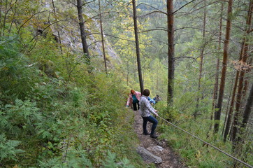 Obraz premium man with backpack walking in forest