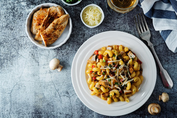 Roasted chicken mushroom pepper pasta in a white plate