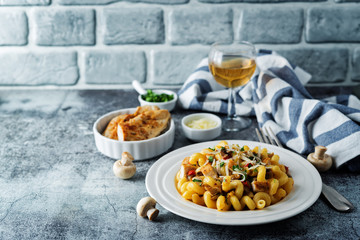 Roasted chicken mushroom pepper pasta in a white plate