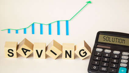 On a white background wooden cubes with the text save, graph and calculator with the text decision