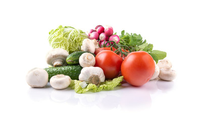 vegetables tomatoes, lettuce, radishes, mushrooms champignon , cucumbers, garlic on a white isolated background