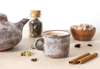 Indian Masala chai tea. Traditional Indian hot drink with milk and spices in a ceramic cup.