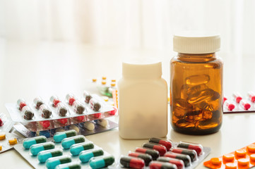 A lot of Colorful Medicine pills, tablets and capsules in packaging and bottle.