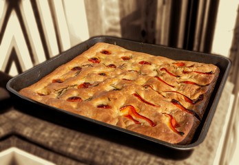 Focaccia cooked with tomato, red pepper and rosemary
