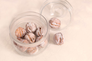 painted in white walnuts in a glass jar with lid