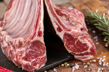 Raw lamb meat in a carnage on wooden background