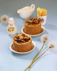 Tarts with mushrooms, caramelized red onion and cheese over on blue background
