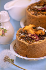 Tarts with mushrooms, caramelized red onion and cheese over on blue background