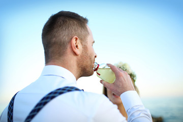 man drinking alcohol.
Elegant young man drinking from a bottle.