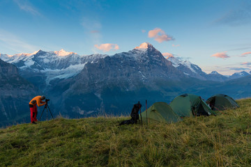 Alpine valley glowing by sunlight. Popular tourist attraction. Dramatic and picturesque scene with...