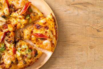 seafood pizza on wood tray
