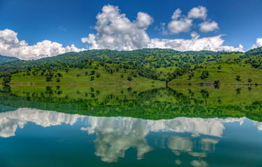 Green fields reflection on a lake in Nepal