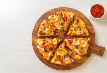seafood pizza on wood tray