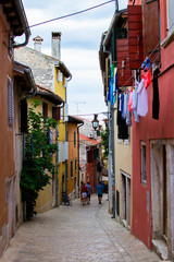 Fototapeta na wymiar Typical narrow street with croatian houses in the picturesque old town of Rovinj, Croatia