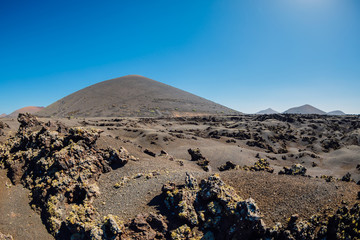 Volcanic landscape with volcano, stones and rocks at Lanzarote in Spain.
