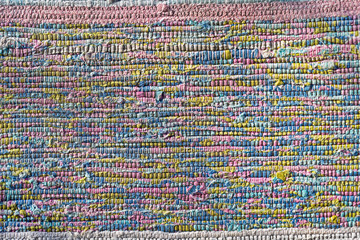Old homespun doormat as background